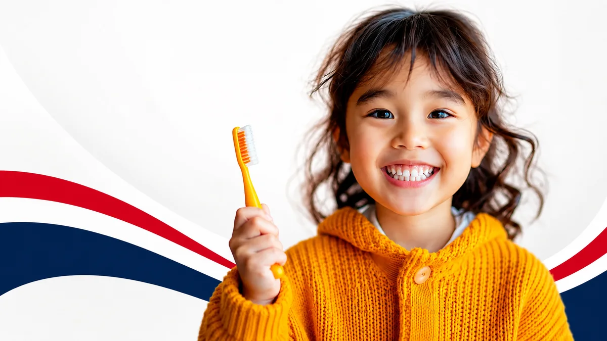 A smiling child holding a toothbrush at Lake County Dental