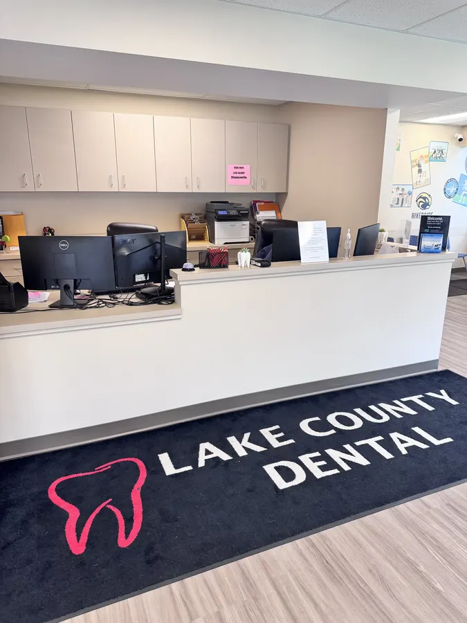 The front desk with the Lake County Dental logo rug