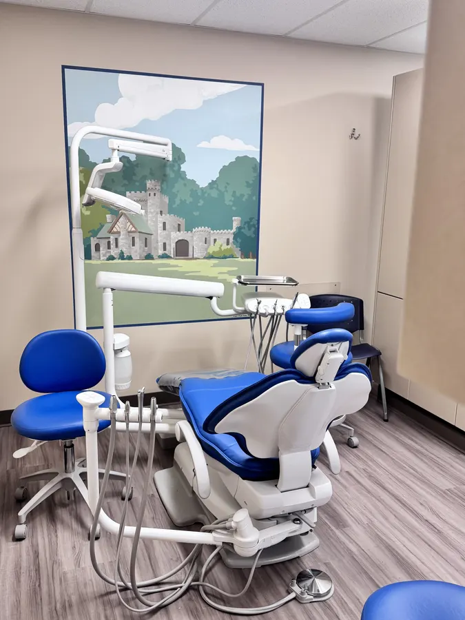 A treatment room with a hand-painted mural of a stone castle in the woods