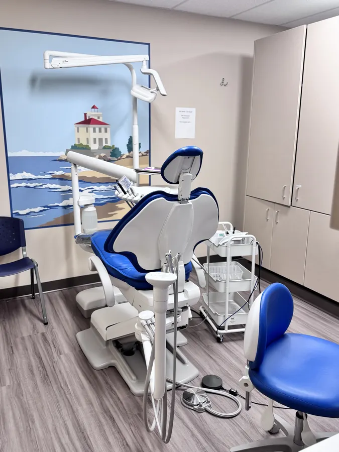 A treatment room with a mural of a lakefront lighthouse